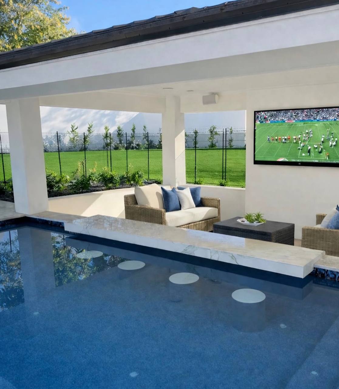 Pool with outdoor living area and TV